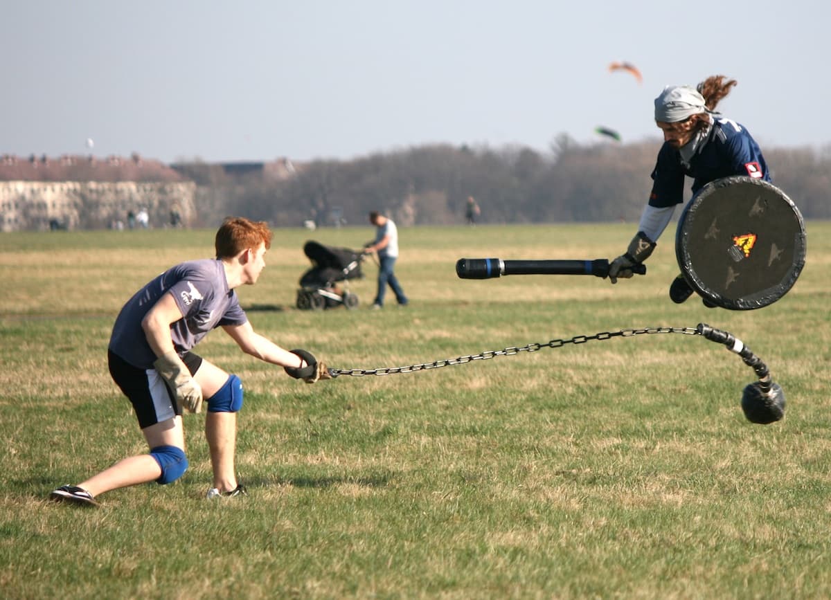 Jugger players leap and defend during a match